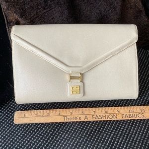 Vintage clutch with gold givenchy logo embellishment.